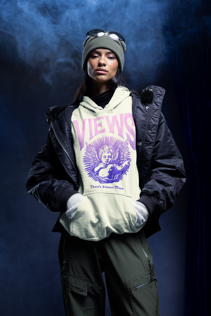 Person wearing a hoodie with 'VIEWS' text and graphic, standing against a dark background